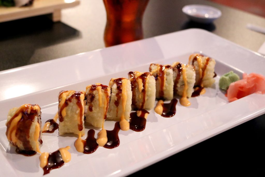 Def Leppard Roll- Crabmeat, tuna, cream cheese, tempura fried with eel sauce, spicy mayo, and topped with crunchy flakes
